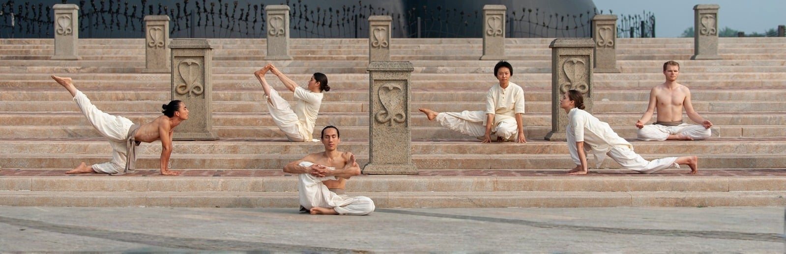 Classical Hatha Yoga practitioners on stone steps