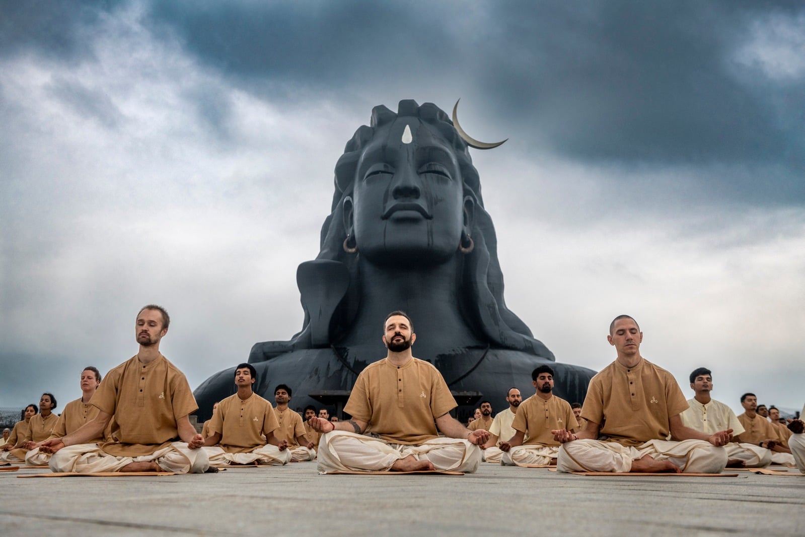 Practitioners meditating before the Adiyogi